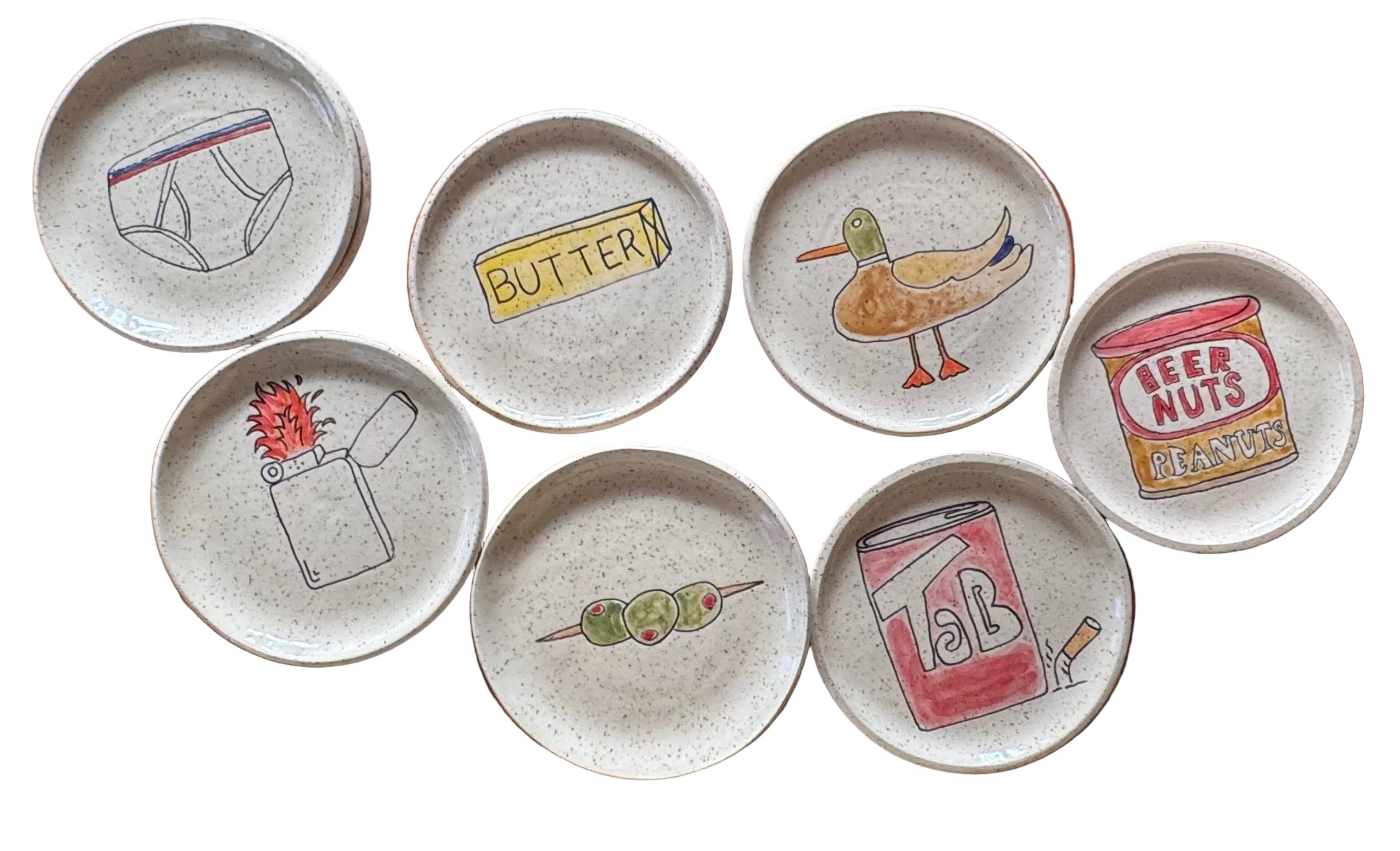 Set of ceramic plates with various illustrations on a wooden surface